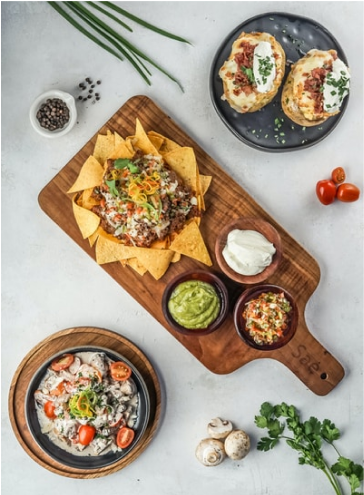 A strange combination meal made up of loaded nachos and baked potatoes. 